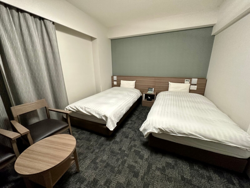 A twin-bed room at Dormy Inn Nagano